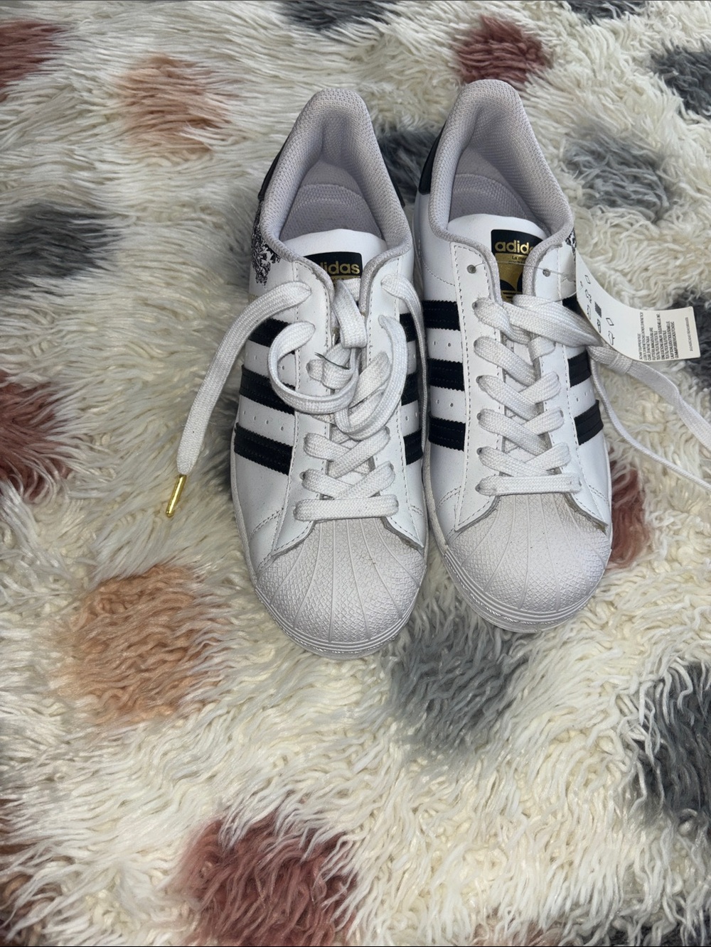 adidas White Sneakers with Black Stripes and Gold Accents